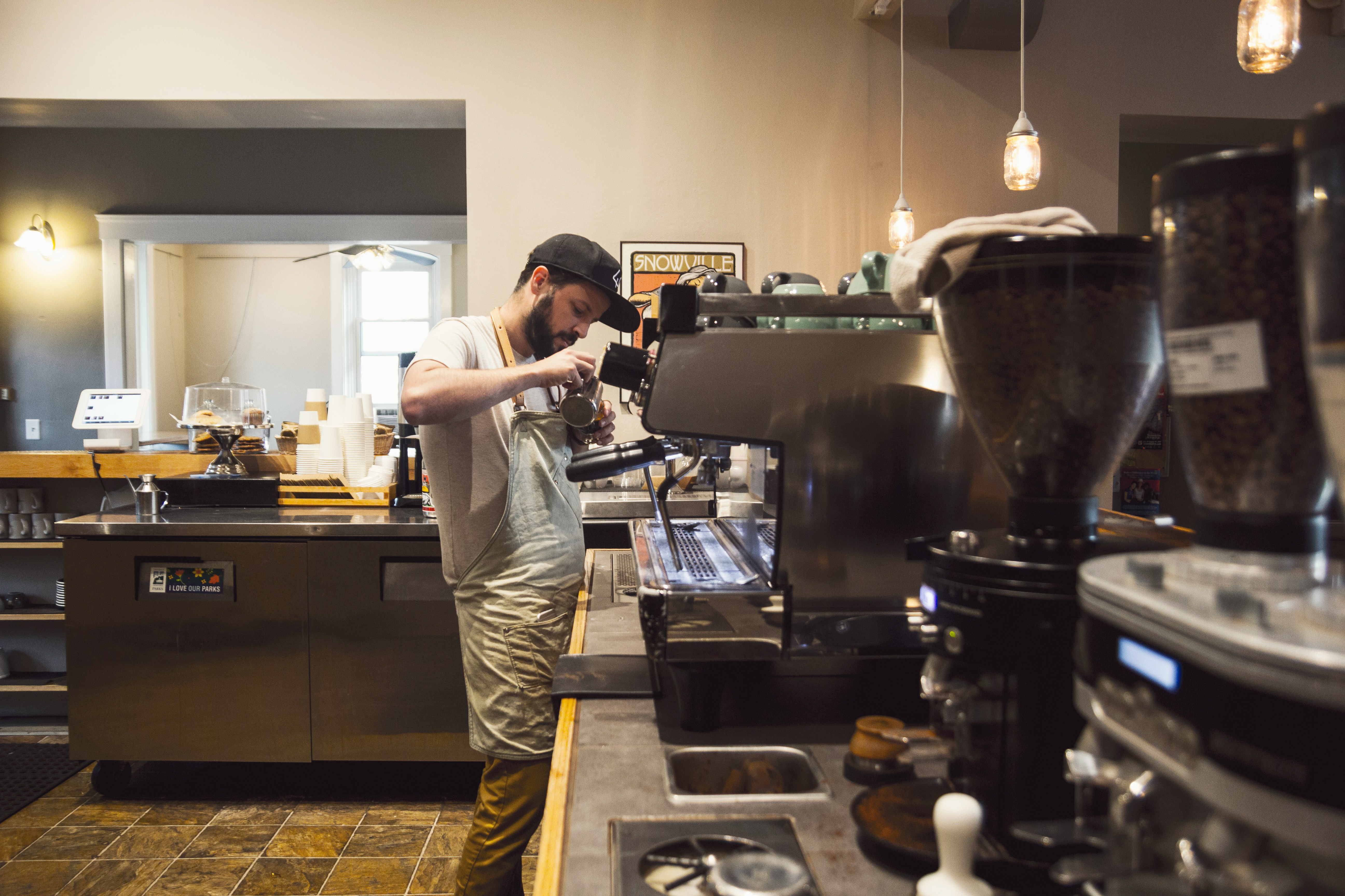 Barista preparing a hazelnut latte in a Calgary café